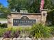 Community sign for The Fountains at Countryside, showcasing stone work, landscaping, and the address at 2500 Winding Creek Blvd # B105, Clearwater, FL 33761