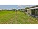 Well-maintained backyard featuring a lush lawn with mature trees at 2609 Lancaster Dr, Sun City Center, FL 33573