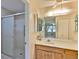 Bathroom featuring a walk-in shower, vanity, and framed mirror at 2609 Lancaster Dr, Sun City Center, FL 33573