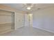 Bedroom featuring a ceiling fan, closet, carpet and an ensuite at 2609 Lancaster Dr, Sun City Center, FL 33573