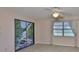 Bright bedroom with tile flooring, a window, ceiling fan, and a closet with a unique mural at 2609 Lancaster Dr, Sun City Center, FL 33573