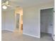 Bedroom featuring tile floors, neutral walls, closet with shelving and connecting full bathroom at 2609 Lancaster Dr, Sun City Center, FL 33573