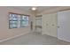 Bedroom featuring a ceiling fan, carpet, closet, and a large window at 2609 Lancaster Dr, Sun City Center, FL 33573