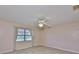 Bedroom featuring neutral walls, tile flooring, a ceiling fan, and a window with blinds at 2609 Lancaster Dr, Sun City Center, FL 33573
