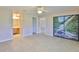 Large bedroom with tile flooring, access to bathroom, closet with mural, and backyard views at 2609 Lancaster Dr, Sun City Center, FL 33573