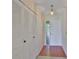 Bright hallway featuring a tiled floor, closet, and a front door with glass panels at 2609 Lancaster Dr, Sun City Center, FL 33573