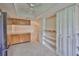 Bright eat-in kitchen with tile flooring, wooden cabinets, stainless steel refrigerator, and pantry storage at 2609 Lancaster Dr, Sun City Center, FL 33573