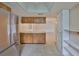 Open concept kitchen with tile flooring, wooden cabinets, stainless appliances, and pantry at 2609 Lancaster Dr, Sun City Center, FL 33573