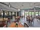 Bright restaurant with tables, chairs, and large windows showcasing outdoor views for a pleasant dining experience at 2609 Lancaster Dr, Sun City Center, FL 33573