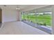 Bright sunroom with sliding glass doors leading to an outdoor patio and lawn at 2609 Lancaster Dr, Sun City Center, FL 33573