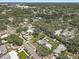 An aerial shot displays the property with a pool and the surrounding residential area at 2718 Boca Ciega N Dr, St Petersburg, FL 33710