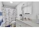 Bright bathroom featuring a vanity sink, a mirror, and shower at 2718 Boca Ciega N Dr, St Petersburg, FL 33710