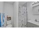 Bathroom featuring a toilet, shower with curtain, and vanity sink at 2718 Boca Ciega N Dr, St Petersburg, FL 33710