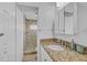 Bathroom vanity features a granite countertop and a shower with decorative tile at 2718 Boca Ciega N Dr, St Petersburg, FL 33710