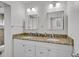 Bright bathroom with dual sinks, granite counters, and matching cabinets at 2718 Boca Ciega N Dr, St Petersburg, FL 33710