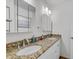 Bathroom with dual sinks and granite counters offers plenty of space for two at 2718 Boca Ciega N Dr, St Petersburg, FL 33710