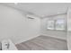 Spacious bedroom featuring wood flooring, an air conditioner, and ample natural light at 2718 Boca Ciega N Dr, St Petersburg, FL 33710