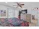 Bedroom with a slider to the pool area, a flat screen tv, and warm natural lighting at 2718 Boca Ciega N Dr, St Petersburg, FL 33710