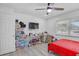 Well lit bedroom featuring a ceiling fan, wood flooring, and a window with natural light at 2718 Boca Ciega N Dr, St Petersburg, FL 33710