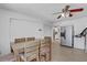 Bright dining area featuring a wood table, modern ceiling fan, and stainless steel refrigerator at 2718 Boca Ciega N Dr, St Petersburg, FL 33710