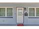 Close-up of the home's entrance featuring a decorative door, mailbox, and stylish outdoor lighting at 2718 Boca Ciega N Dr, St Petersburg, FL 33710