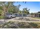 Single-story home with a well-manicured front yard, and mature shade trees at 2718 Boca Ciega N Dr, St Petersburg, FL 33710