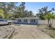 Cozy single-story home has a well-kept lawn and mature trees at 2718 Boca Ciega N Dr, St Petersburg, FL 33710