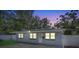 Charming single-story home with a well-maintained gray exterior and mature trees at 2718 Boca Ciega N Dr, St Petersburg, FL 33710