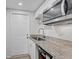 Modern kitchen equipped with granite counters, a sink, and stainless steel appliances at 2718 Boca Ciega N Dr, St Petersburg, FL 33710