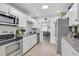Modern kitchen featuring stainless steel appliances, granite countertops and white cabinetry at 2718 Boca Ciega N Dr, St Petersburg, FL 33710