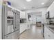Bright kitchen with stainless steel appliances, white cabinets and a view into the living area at 2718 Boca Ciega N Dr, St Petersburg, FL 33710