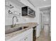 Well-lit kitchen featuring granite counters, an undermount microwave, and modern cabinetry at 2718 Boca Ciega N Dr, St Petersburg, FL 33710