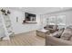 Well-lit living area showcasing modern decor, comfortable seating, and stylish wood-look flooring at 2718 Boca Ciega N Dr, St Petersburg, FL 33710