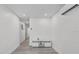 Modern living room featuring vinyl floors, neutral paint, and ample lighting at 2718 Boca Ciega N Dr, St Petersburg, FL 33710