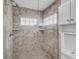 Tiled shower with glass door and block glass window accents for a modern feel at 2718 Boca Ciega N Dr, St Petersburg, FL 33710