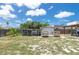 Fenced backyard with a chicken coop and storage shed at 2809 49Th N St, St Petersburg, FL 33710