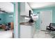 Eat-in kitchen featuring white cabinets, granite countertop, and door to the bedroom at 2809 49Th N St, St Petersburg, FL 33710