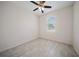 The bedroom has neutral-colored tiled floors, a ceiling fan, and a window at 2810 N 75Th St, Tampa, FL 33619