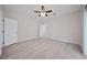This bedroom features light grey floors, a ceiling fan, and a white door to the walk-in closet at 2810 N 75Th St, Tampa, FL 33619