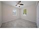 The bedroom has windows and neutral-colored tiled floors at 2810 N 75Th St, Tampa, FL 33619