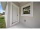 Inviting entryway showcasing a white door and trim, complemented by a nearby window for natural light at 2810 N 75Th St, Tampa, FL 33619