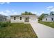 Charming single-story home features a well-manicured lawn and a driveway leading to an attached one-car garage at 2810 N 75Th St, Tampa, FL 33619