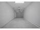 A well-lit garage space with clean concrete floors and white walls offers ample room for parking and storage at 2810 N 75Th St, Tampa, FL 33619