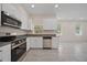 Modern kitchen boasting stainless steel appliances, granite countertops, and white cabinetry at 2810 N 75Th St, Tampa, FL 33619