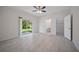 Spacious main bedroom with tiled flooring, closet space, and sliding glass doors to backyard at 2810 N 75Th St, Tampa, FL 33619