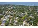 Expansive aerial view of a property nestled amongst mature trees near a scenic body of water at 2822 W Bay Ave, Tampa, FL 33611