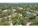 An aerial shot showcases the house surrounded by mature trees in a desirable neighborhood setting at 2822 W Bay Ave, Tampa, FL 33611