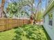 Backyard offers a treehouse, lush artificial turf, and a wooden fence for privacy at 2822 W Bay Ave, Tampa, FL 33611