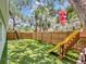 Expansive backyard with a slide and artificial turf offers a perfect space for Gathering fun and recreation at 2822 W Bay Ave, Tampa, FL 33611