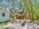 Large backyard with a custom treehouse, stone patio, and lush greenery provides a fun outdoor retreat at 2822 W Bay Ave, Tampa, FL 33611